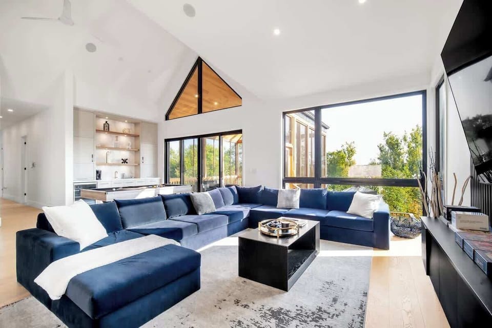 Gather together in the spacious and stunning Great Room, the central hub of the home. Anchored by a huge, luxurious velvet sectional sofa, this space is perfect for family movie nights or simply relaxing after a day of adventure.