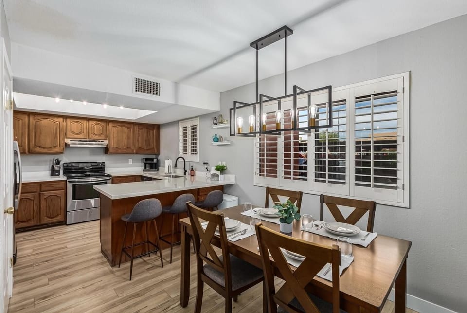 Large dining table with extra bar stools.