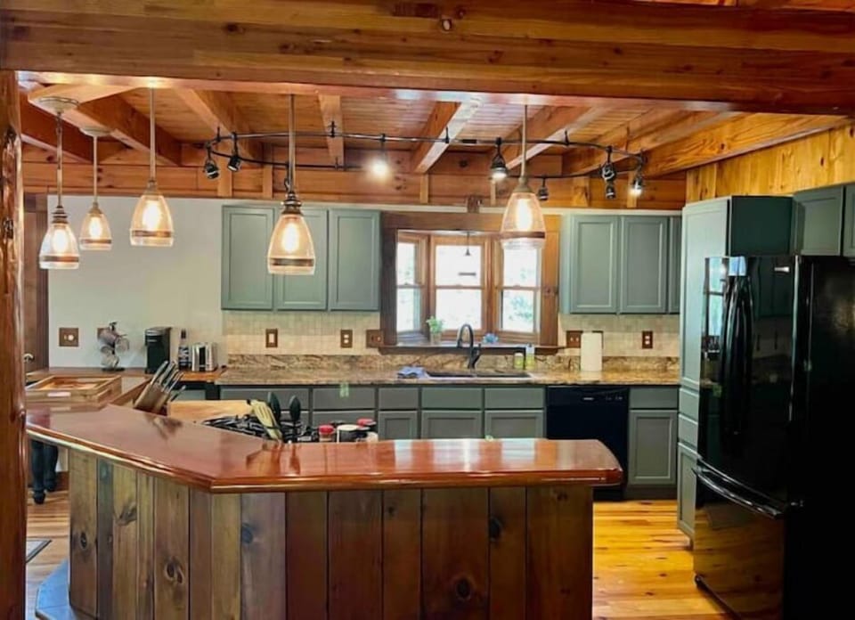 Well-equipped kitchen with easy access to the back deck with Smoker/Grill combo.