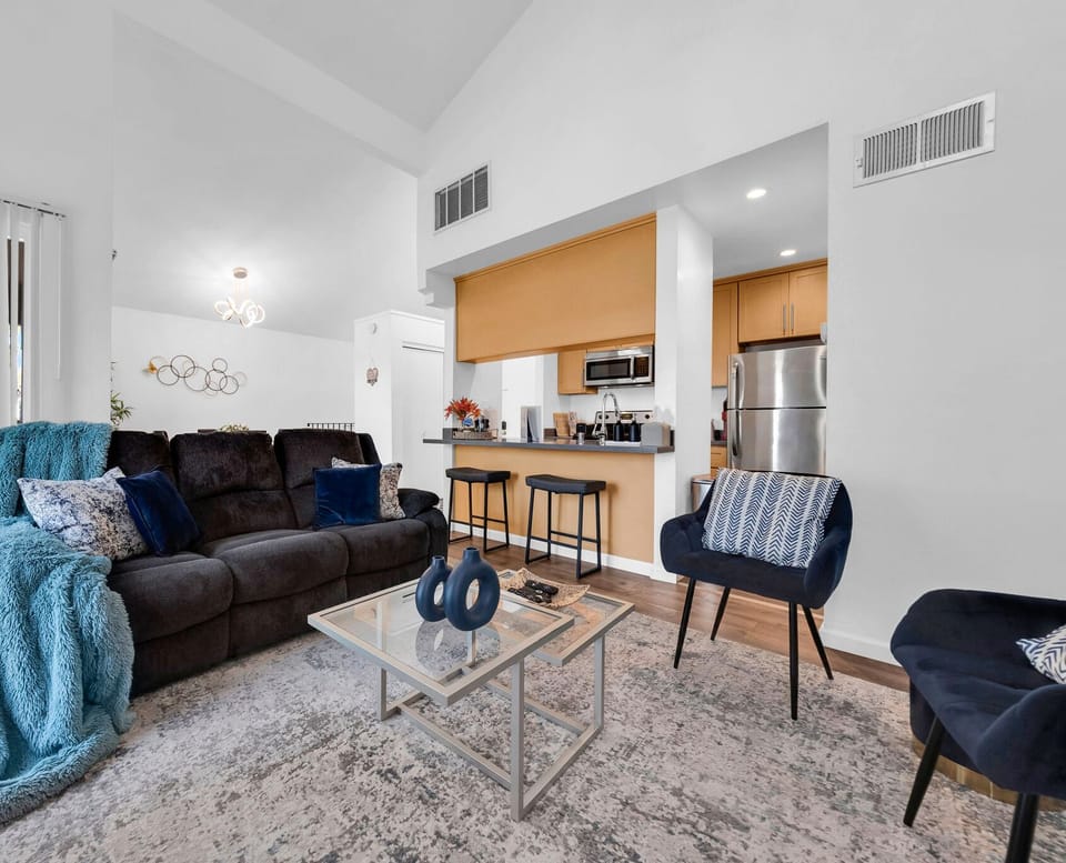 Cozy living area with a plush couch and extra seating.