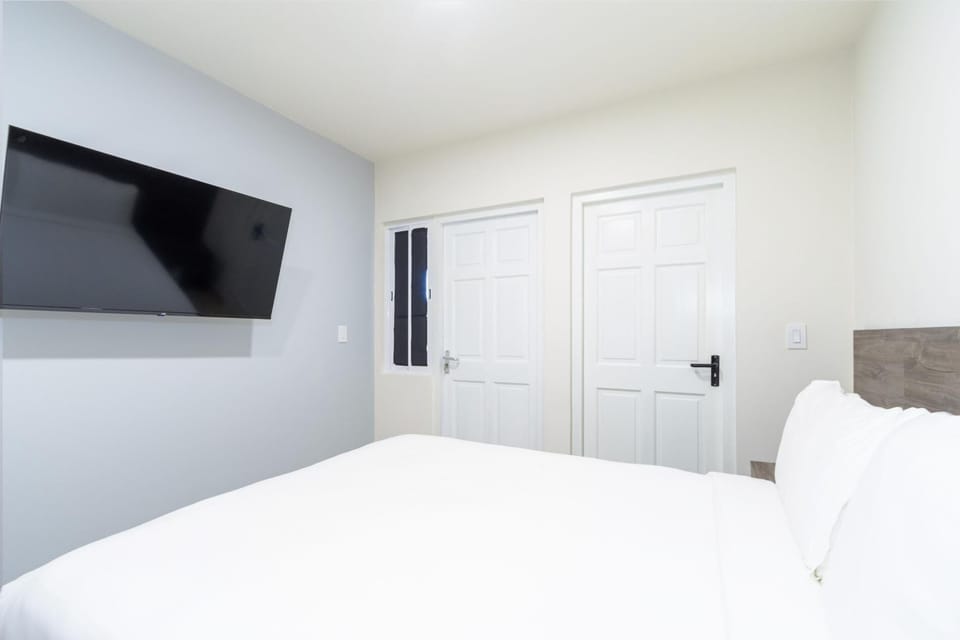 This bedroom features a queen sized bed and its own private bathroom.