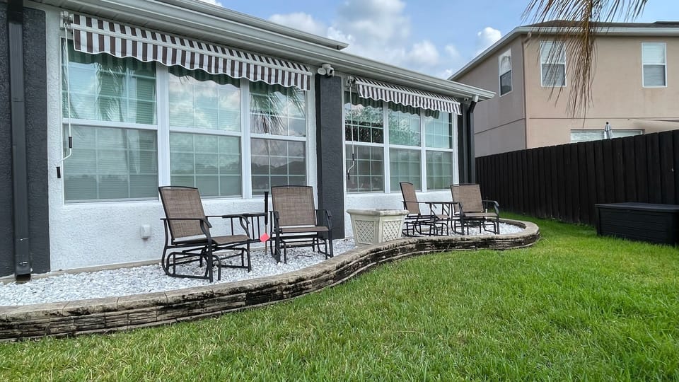 The beautiful yard features multiple seating areas to enjoy the lake views.
