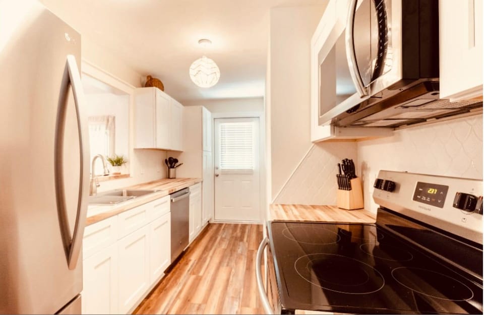 Full custom kitchen. Stainless and butcher block finishes.