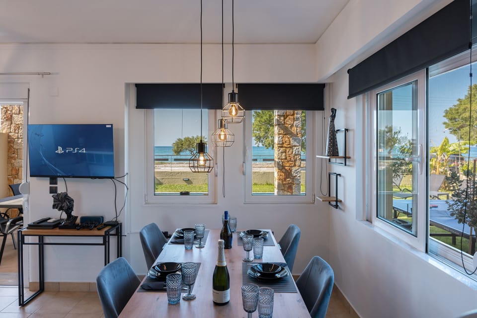 Adjacent to the living room, a stylish dining area which accommodates up to six guests