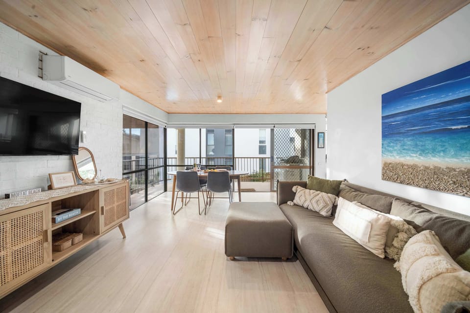 Open plan living and dining area styled with contemporary coastal décor