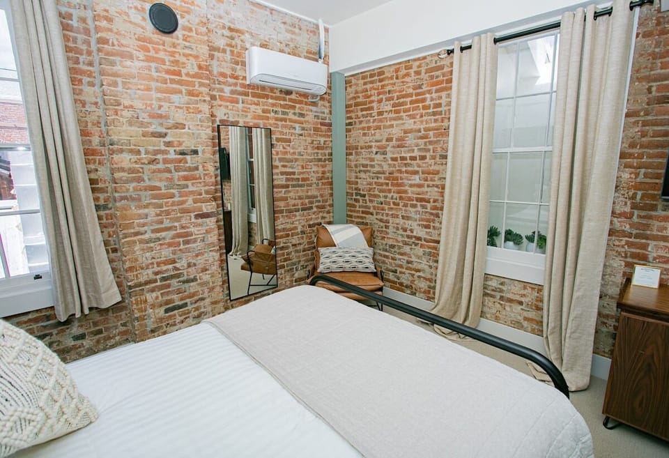 Sleep in ultimate comfort on our Queen Bed, adorned with luxurious linens for a restful, indulgent experience.