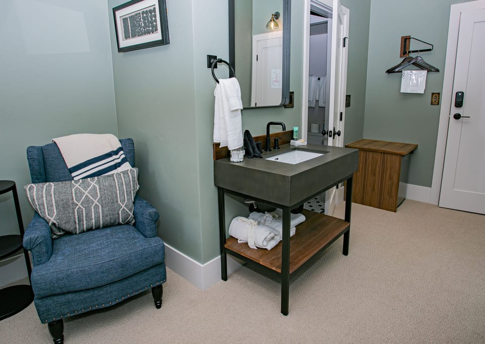 Cozy corner with a plush chair and modern sink for ultimate comfort.