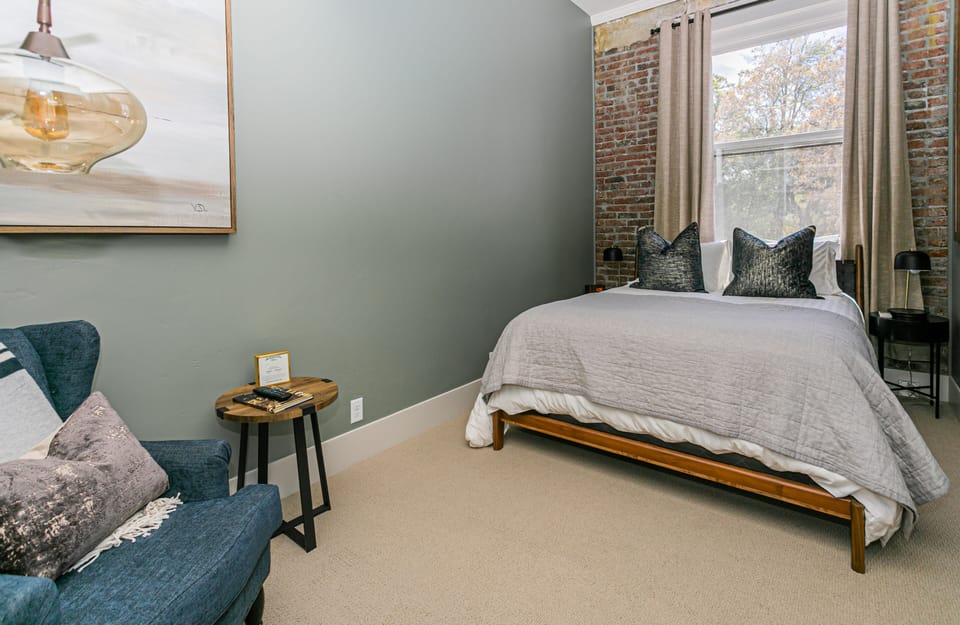 Cozy and inviting Queen Guest Room, featuring a plush queen-sized bed, contemporary décor, and all the amenities for a restful and comfortable stay
