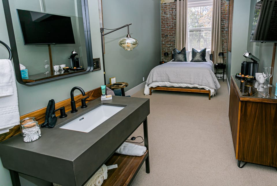 Spacious Queen room featuring a comfortable queen-sized bed, stylish living area, and upscale amenities for a refined and relaxing retreat.