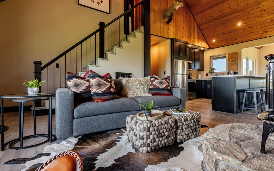Open living room, kitchen and dining area with vaulted ceilings.