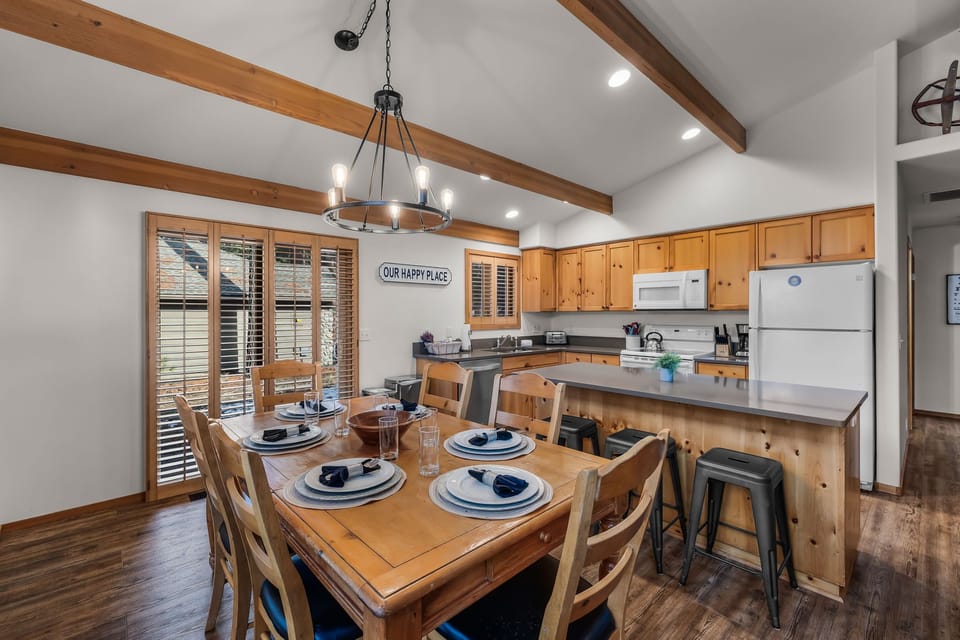 Gather around this warm wood dining table where rustic charm meets modern comfort in your fully-equipped mountain kitchen retreat.
