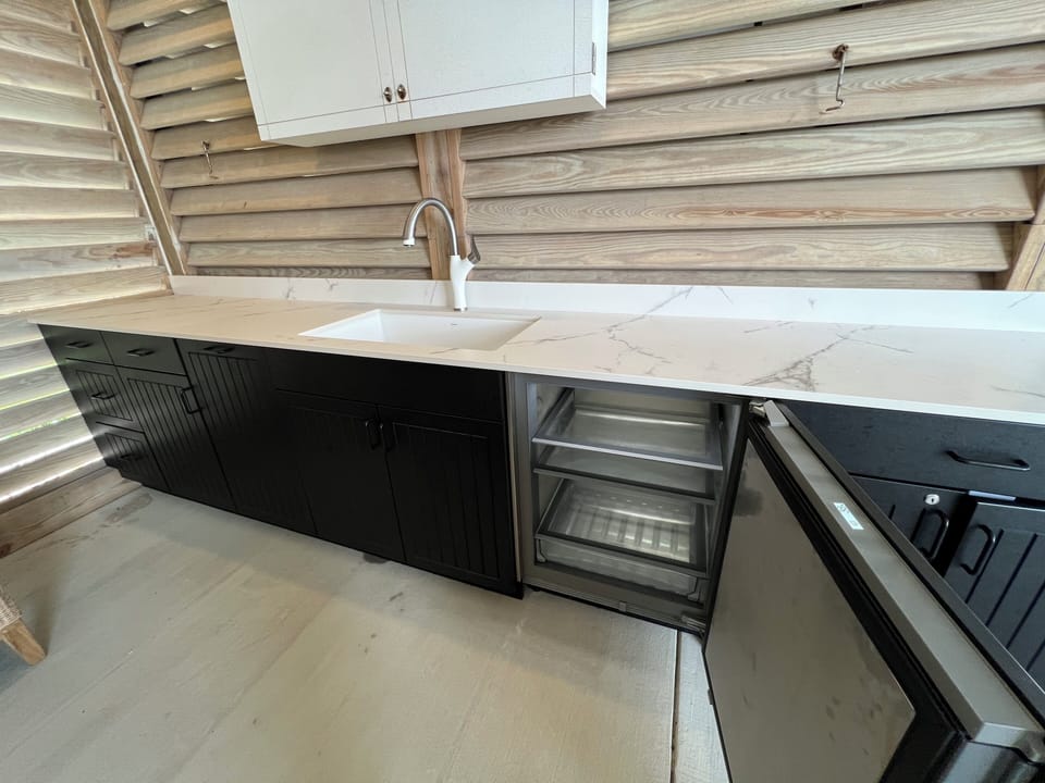 Enclosed tv, sink and mini fridge in the new outdoor entertainment area.