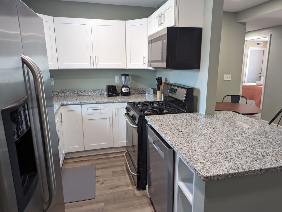 Well equipped kitchen with new cabinets and granite countertops