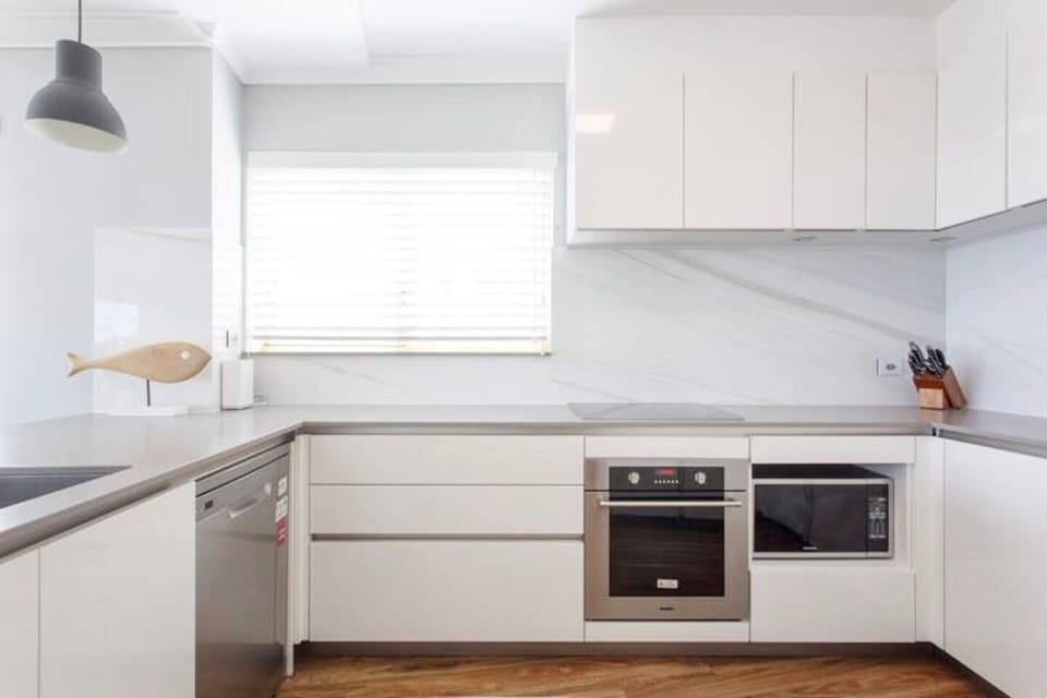 Modern kitchen with stainless steel appliances. 
