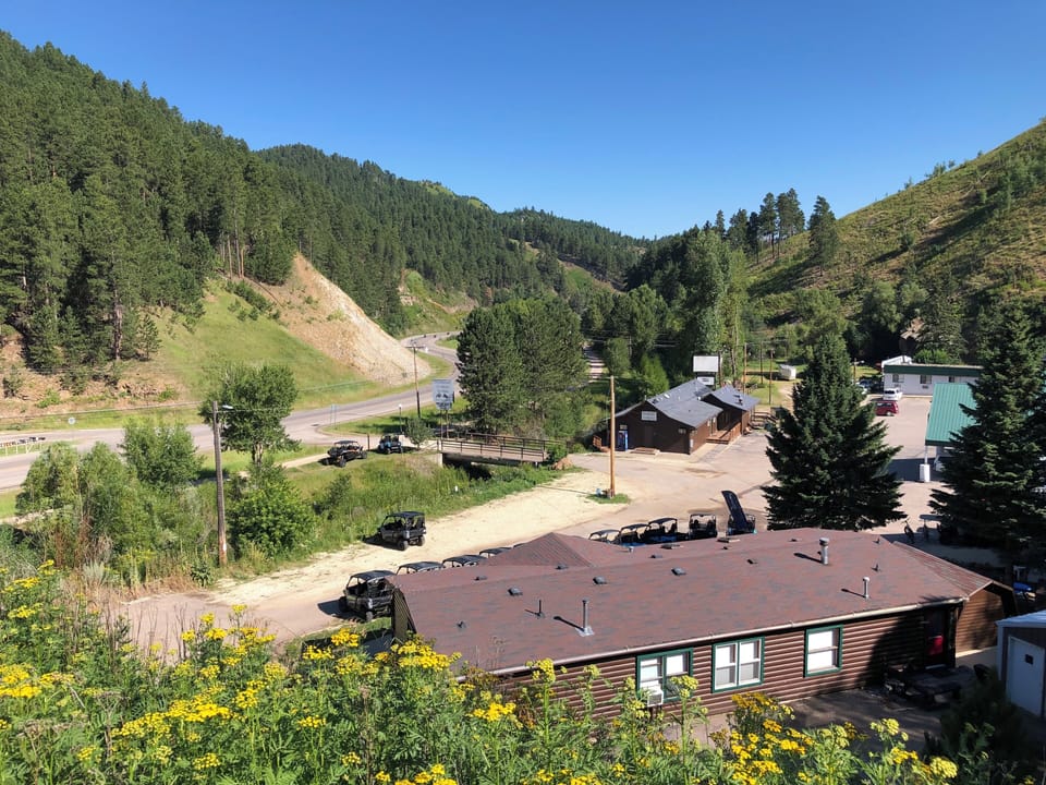 View of property. Building A is the green roof on right in photo.
