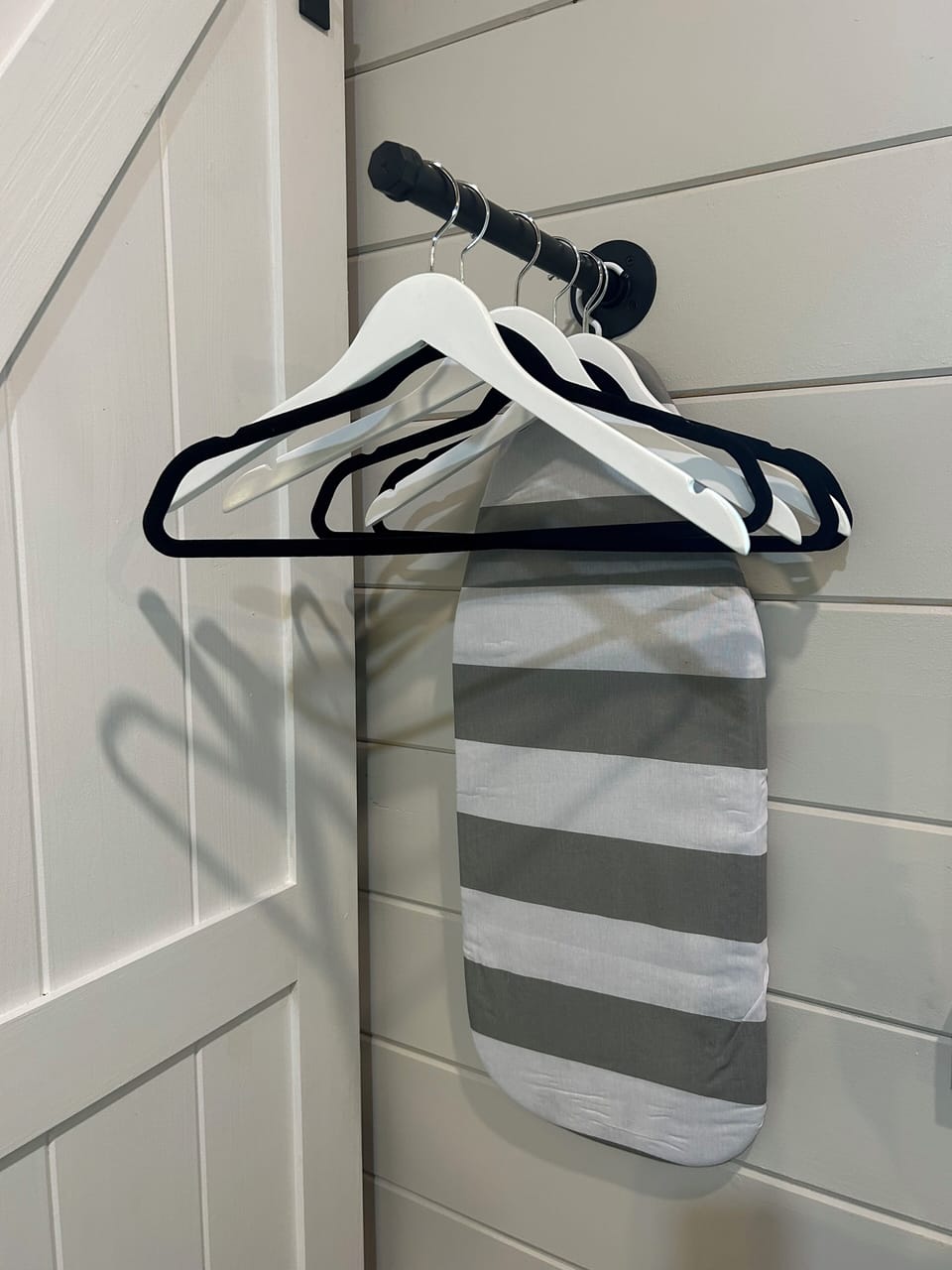 Ironing Board & Clothes Hanging Area in stylish tiny home with fenced yard.
