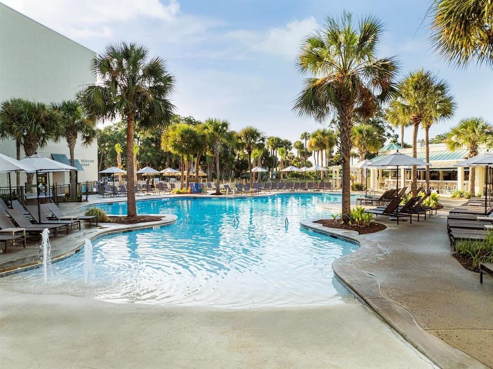 Slip into the sparkling lagoon pool under swaying palms.