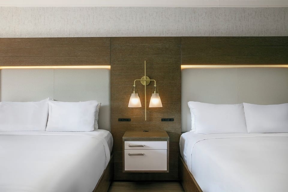Drift off beneath warm lighting and a stylish headboard.