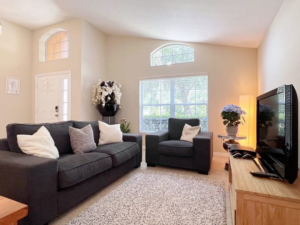 Relax in the comfortable living area featuring plush seating, a large flat-screen TV, and high-speed Wi-Fi—perfect for movie nights, streaming, or unwinding after a day of adventure.