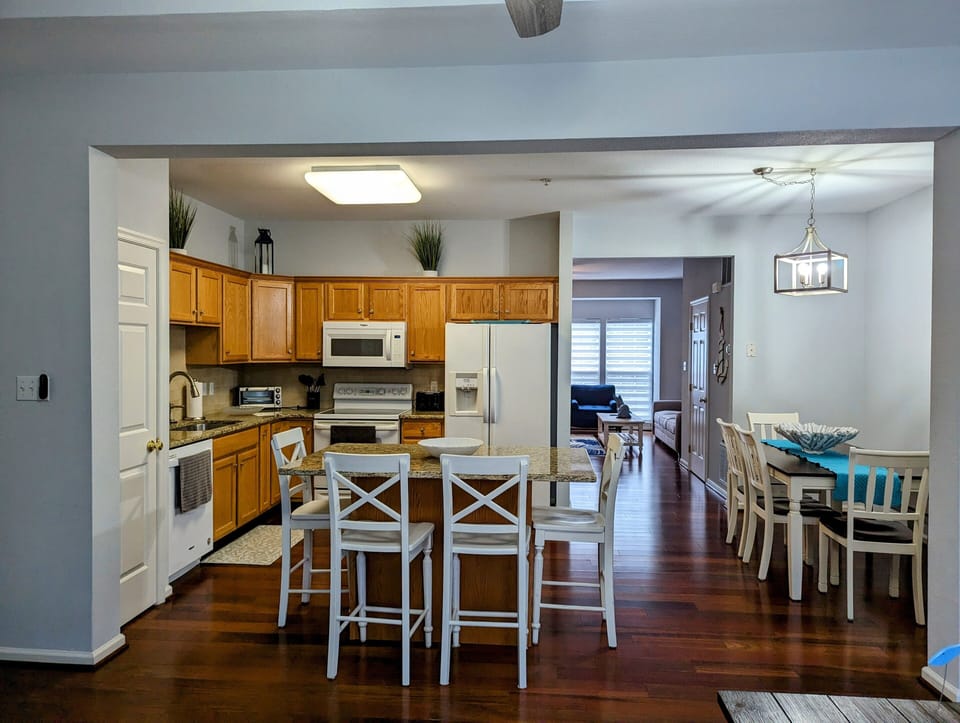 38157 Greenport Lane, South Hampton - kithcen view - Wide-angle view from the kitchen island showing the open-concept flow into the dining area and great room.