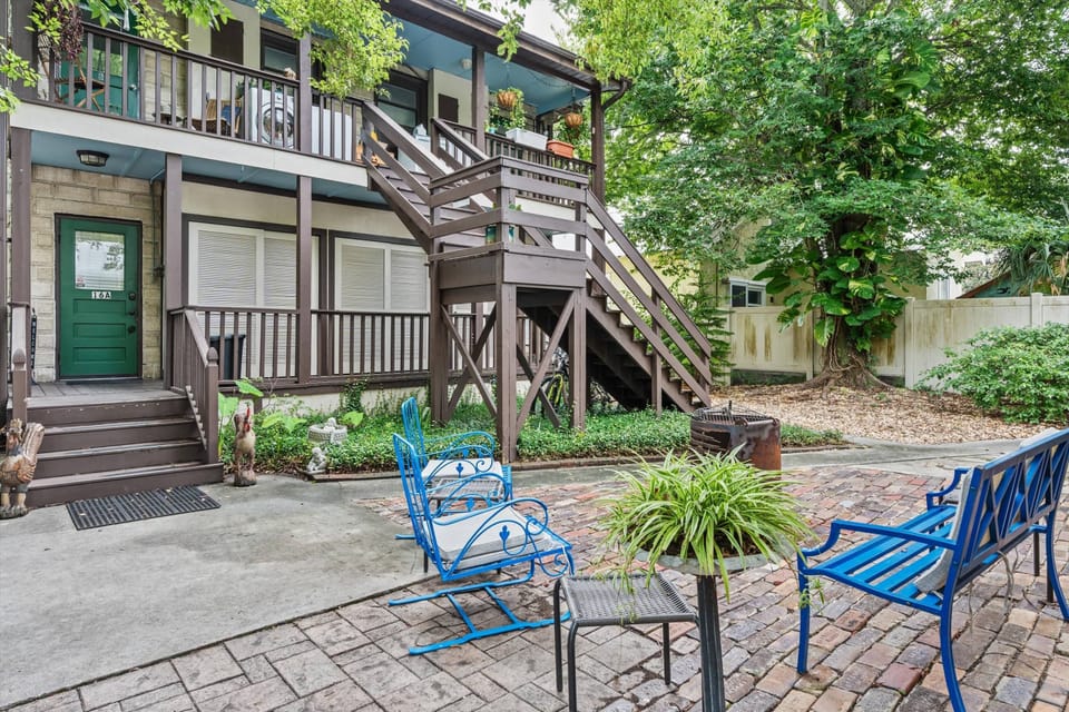 Relax in your private garden courtyard with seating, grill & lush plants.