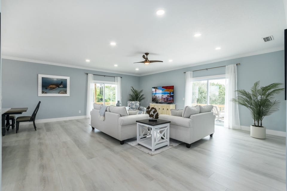 Spacious great room with sliders leading out to wrap around deck