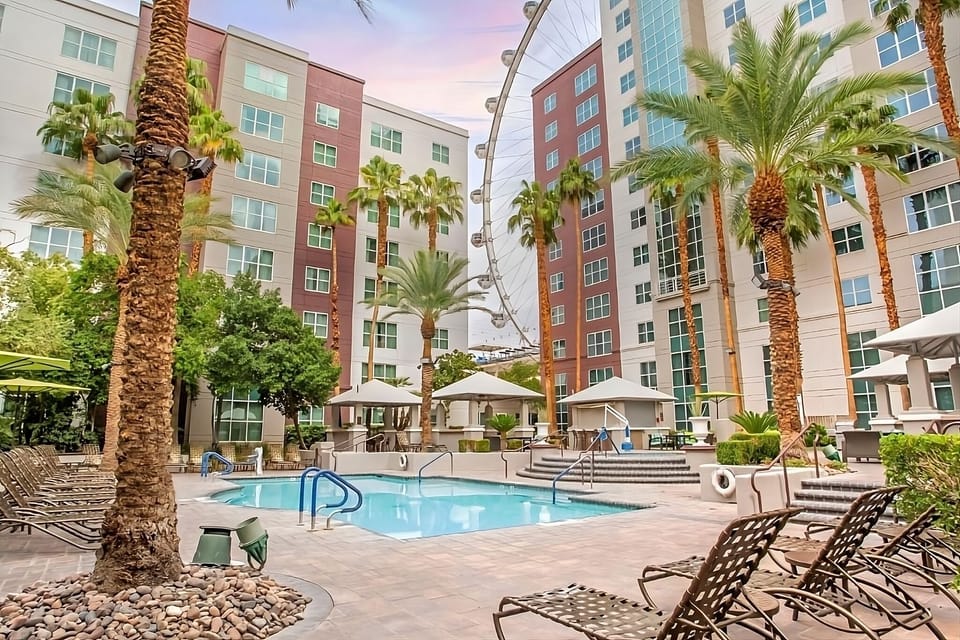 Unwind poolside beneath palm trees and warm sunset skies.