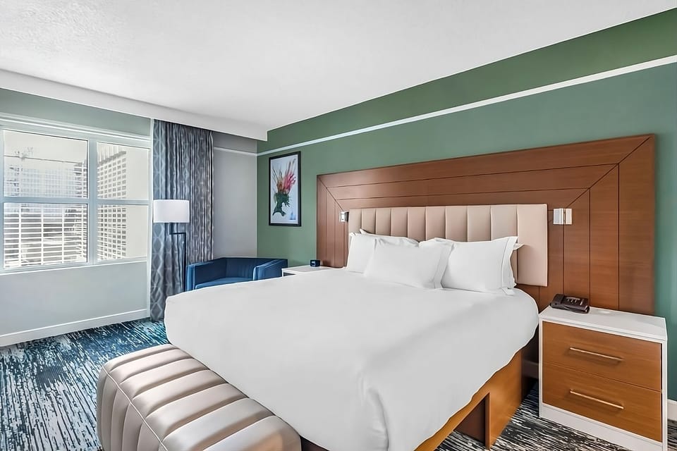Wake up refreshed in crisp linens beside bright windows.