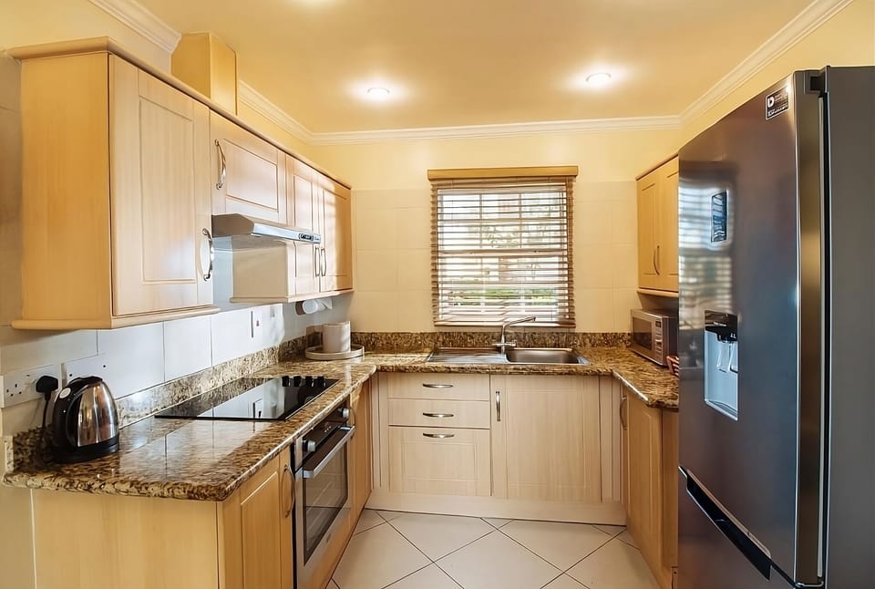 Cook fresh meals in a spotless kitchen with modern appliances.
