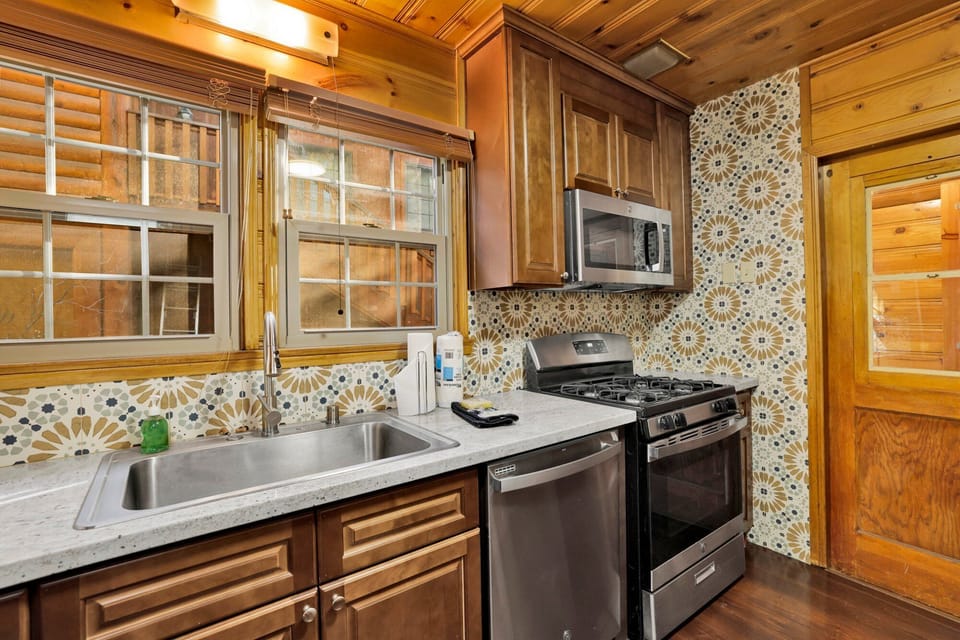 Clean and cozy cabin bathroom with a shower, sink, and toilet—simple, fresh, and comfortable for your everyday needs during a relaxing mountain stay.