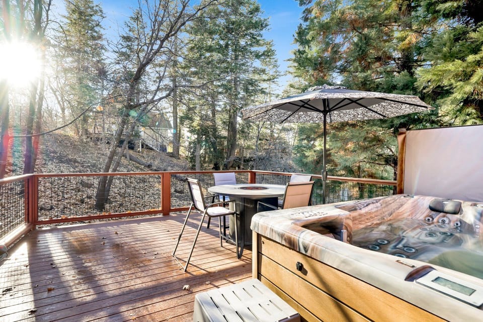 Private outdoor hot tub, surrounded by tall pines, perfect for relaxing under the trees after a day of adventure—enjoy peaceful forest views, fresh air, and a truly rejuvenating stay.