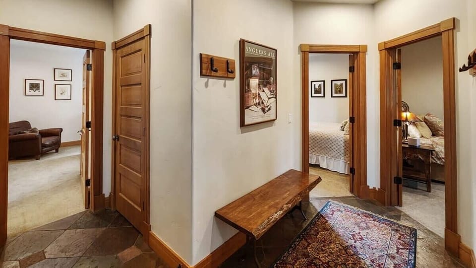 The view of the downstairs hallway where you will find the additional three bedrooms.