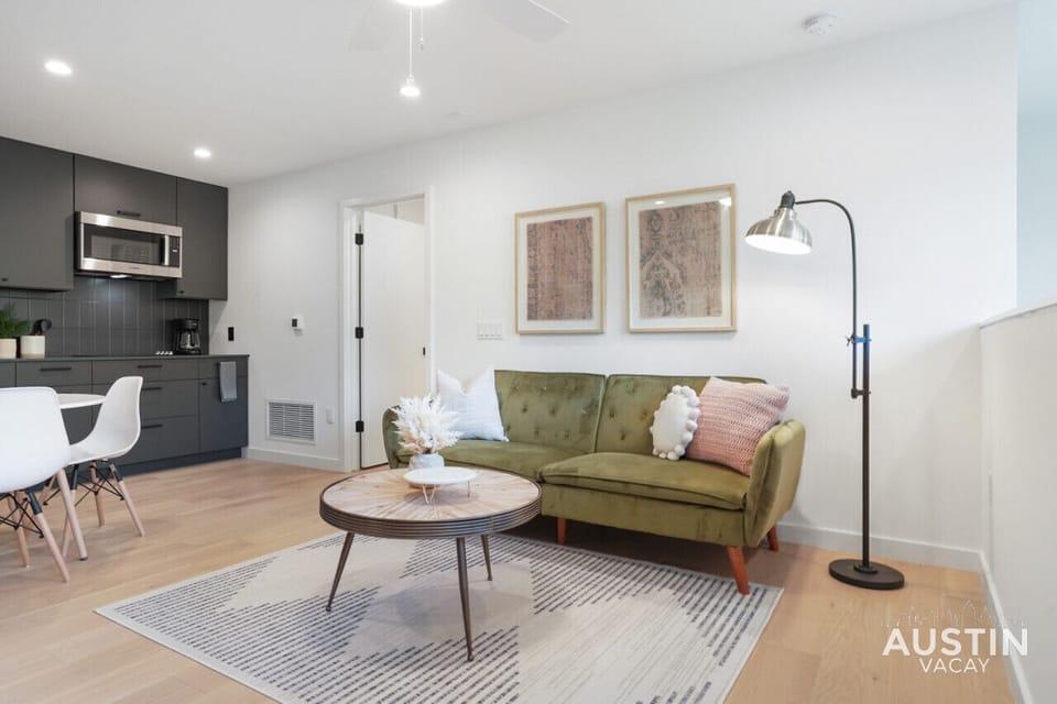 Living room with natural light, convertible sofa, and smart tv