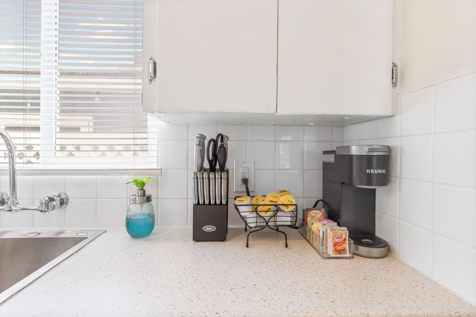 Kitchen: Keurig coffee machine, coffee pods, creamer, knife block, dish soap dispenser 