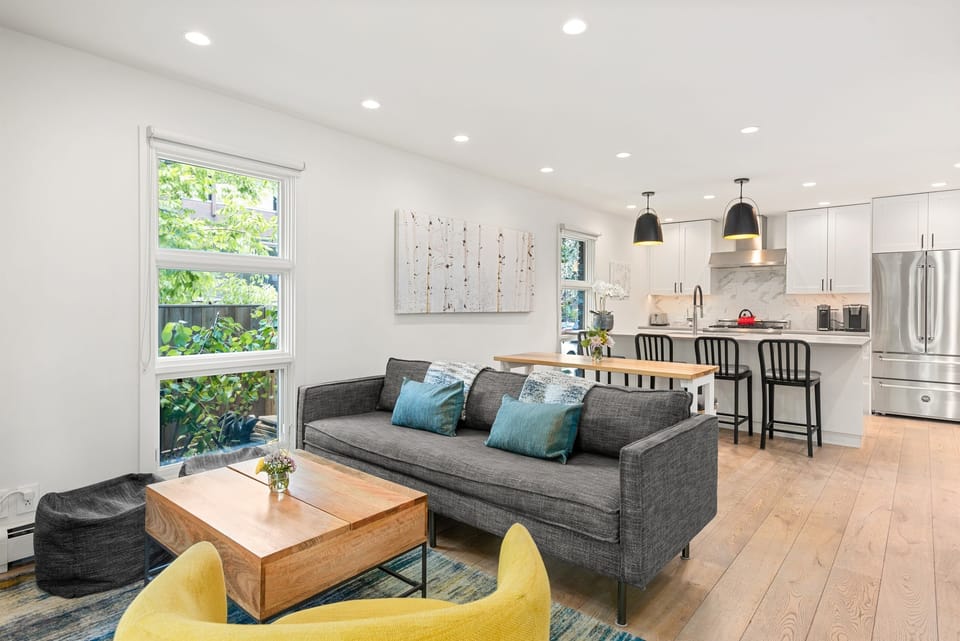 Open kitchen/living/dining area with ample seating.