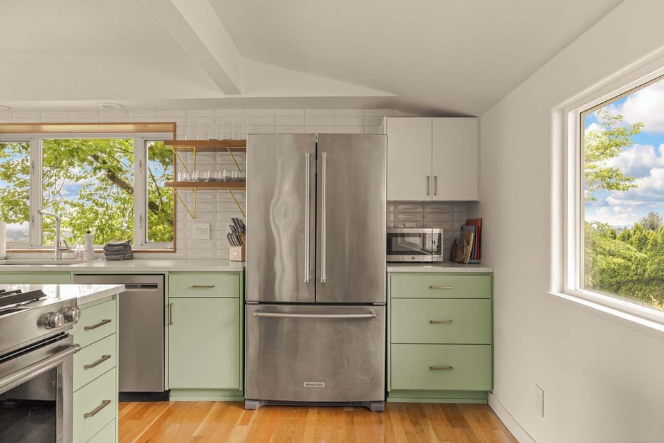 Modern open kitchen with modern appliances and microwave. 