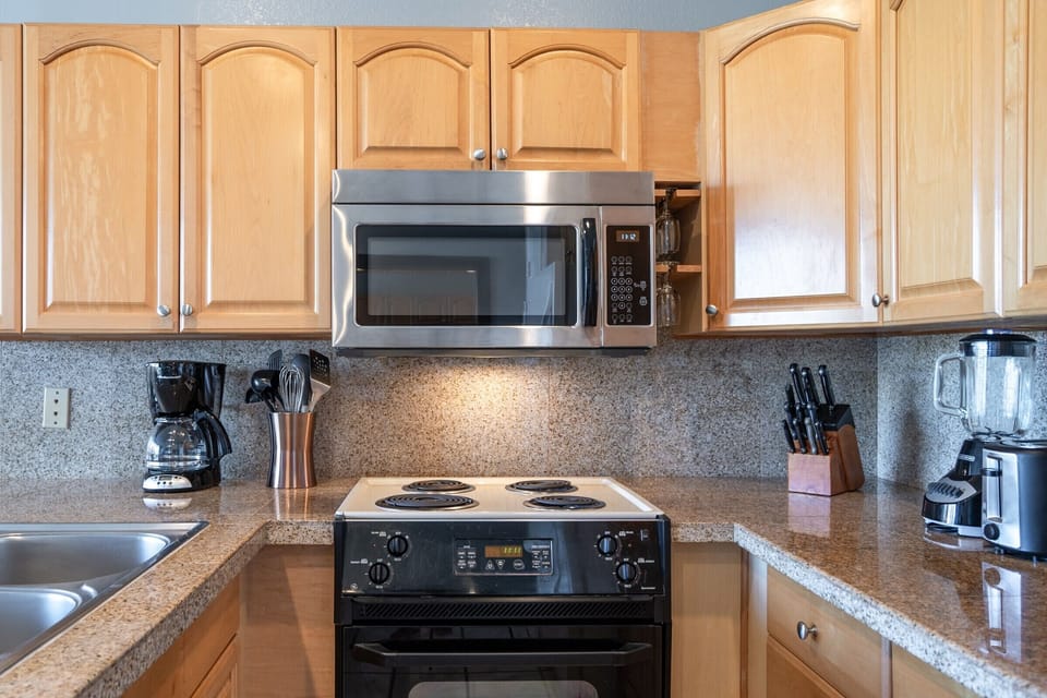 A well-equipped kitchen ready for your culinary adventures, featuring modern appliances and ample counter space for meal prep.