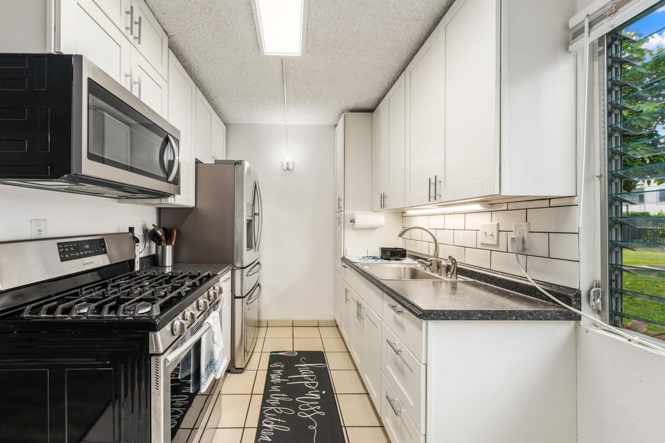 Small galley style kitchen stocked with the essentials