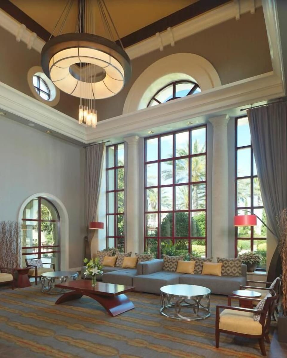 Unwind beneath soaring windows in a serene lounge retreat.