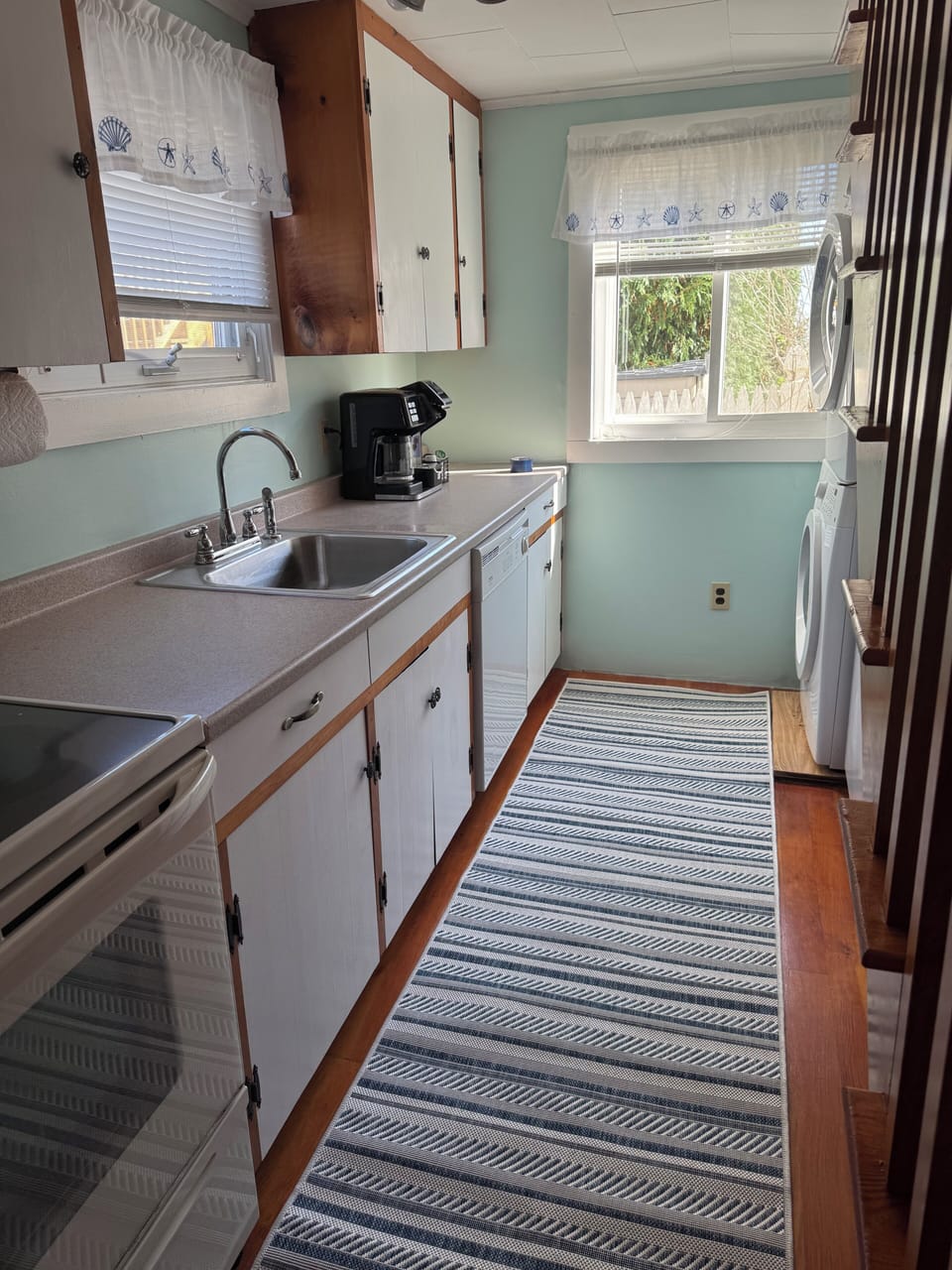 Galley kitchen equipped with refrigerator, dish washer, washer/dryer. 