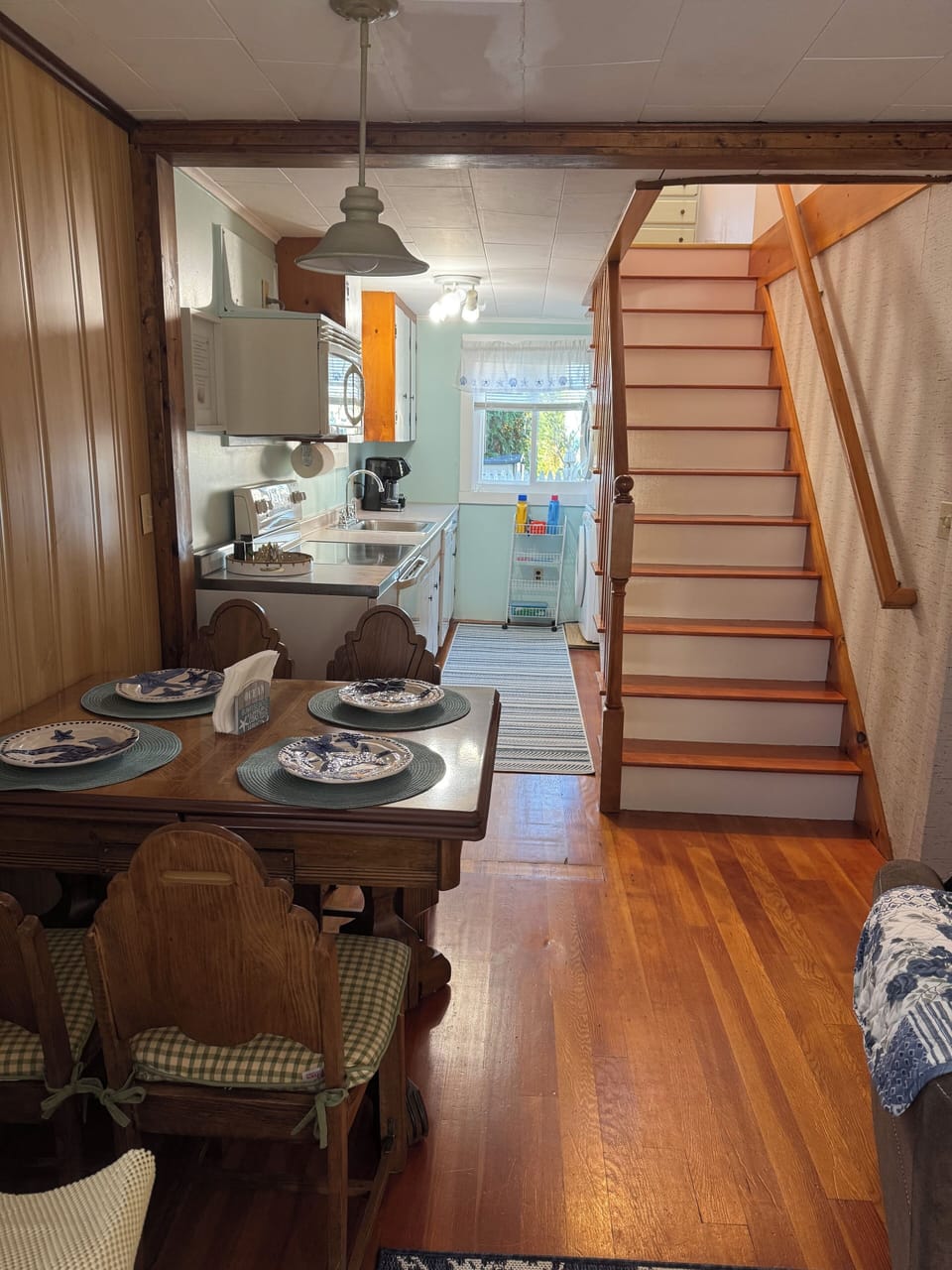 Full view of dining/kitchen/staircase.