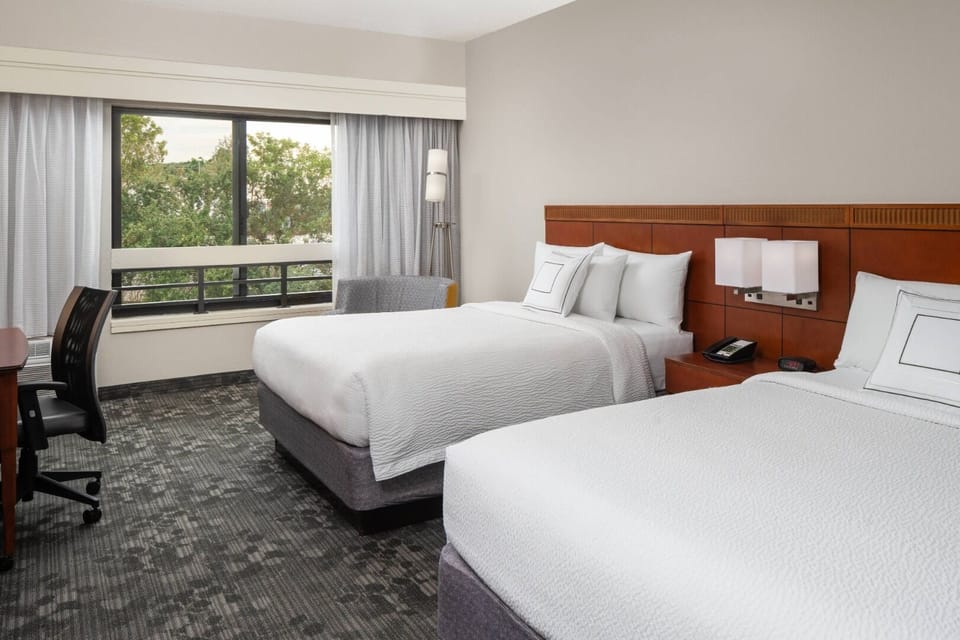Unwind in crisp linens with calming treetop views outside.