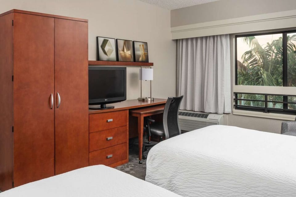Settle in with an in-room workspace, TV, and ample storage.