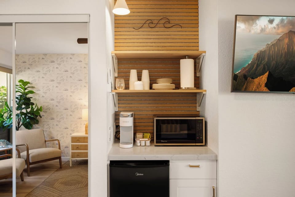 Fridge with small freezer, k-cup coffee maker, microwave, kettle in the cabinet.