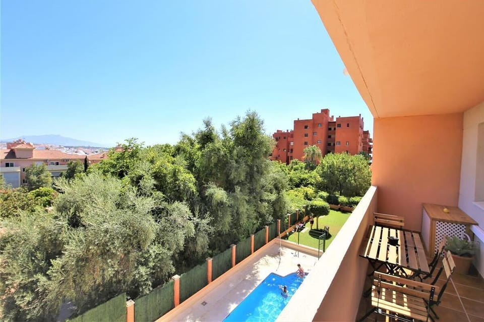 Private terrace with outdoor dining area for six guests and views to the pool and gardens