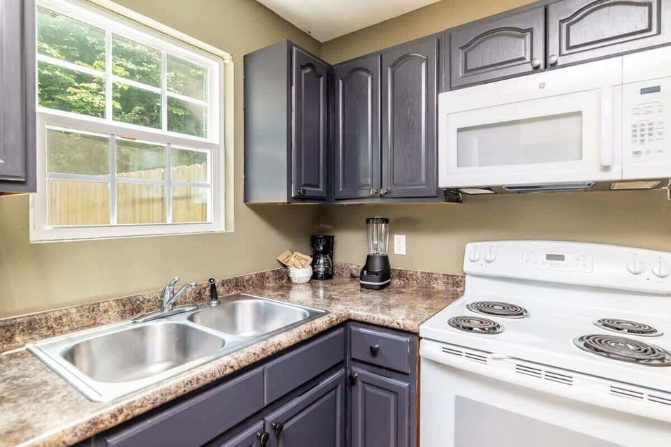 A fully-equipped kitchen with a double sink, microwave, stove and all other cooking cooking basics that you need to prepare some good food!