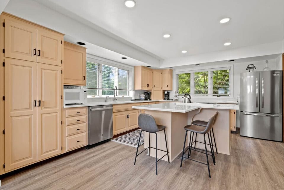Updated, fully stocked kitchen with island seating