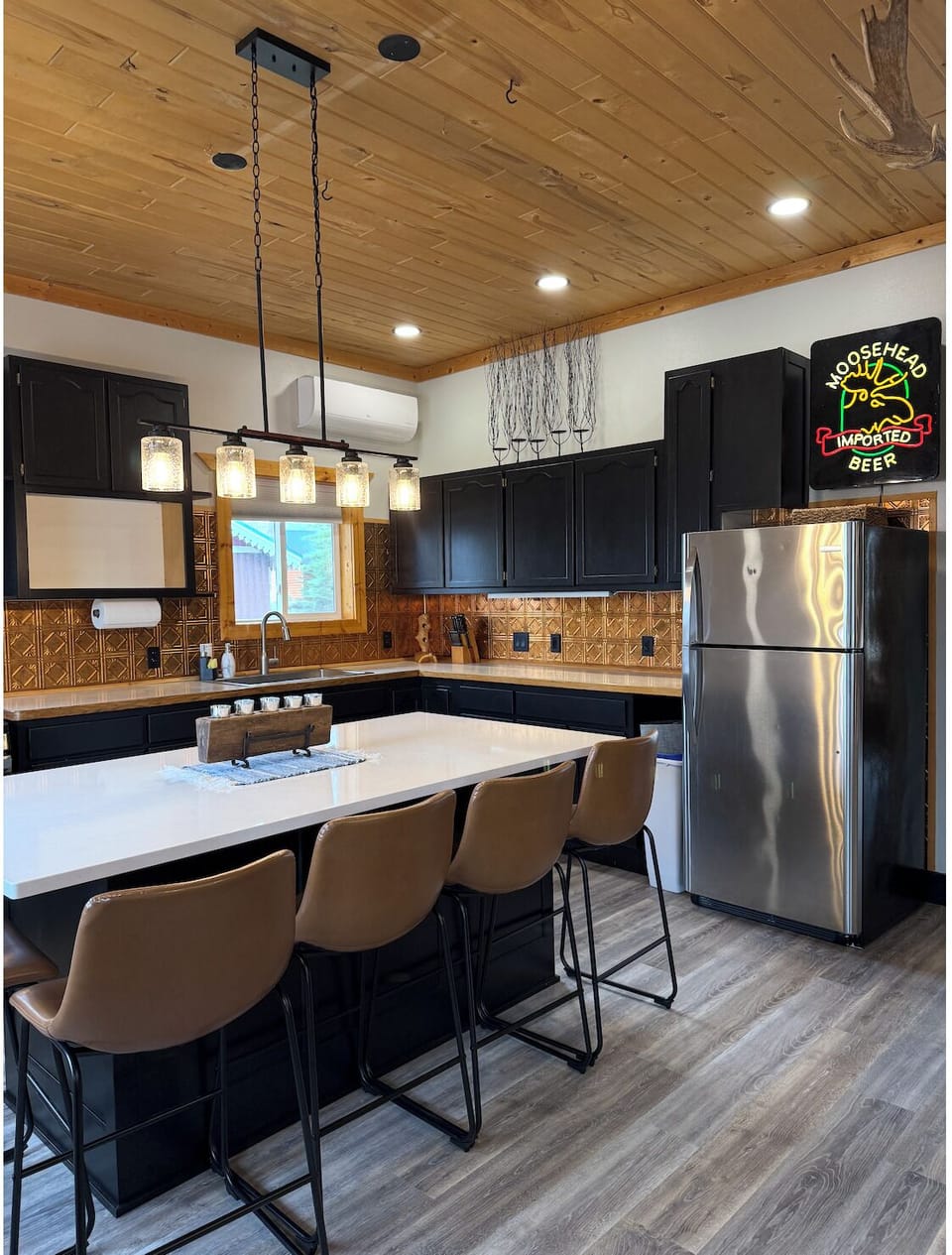 Stainless appliances, pendant lights, copper backsplash. Ready for dinner! 