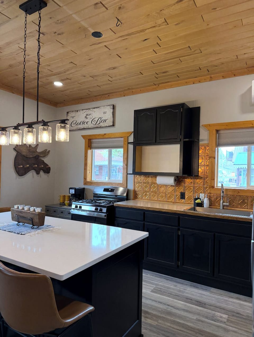 Gas range, coffee bar setup, and plenty of counter space for group cooking.