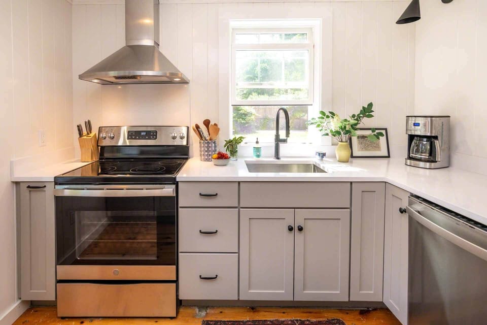 Kitchen Has an Electric Stove and Overlooks the Backyard